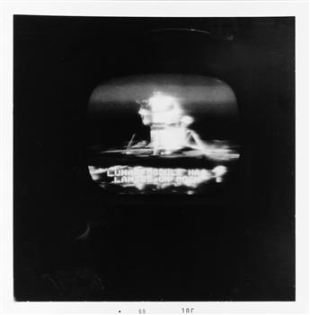 (TELELVISION/LUNAR LANDING) A set of 23 photographs made from a television screen broadcasting the 1969 Apollo 11 Moon walk.